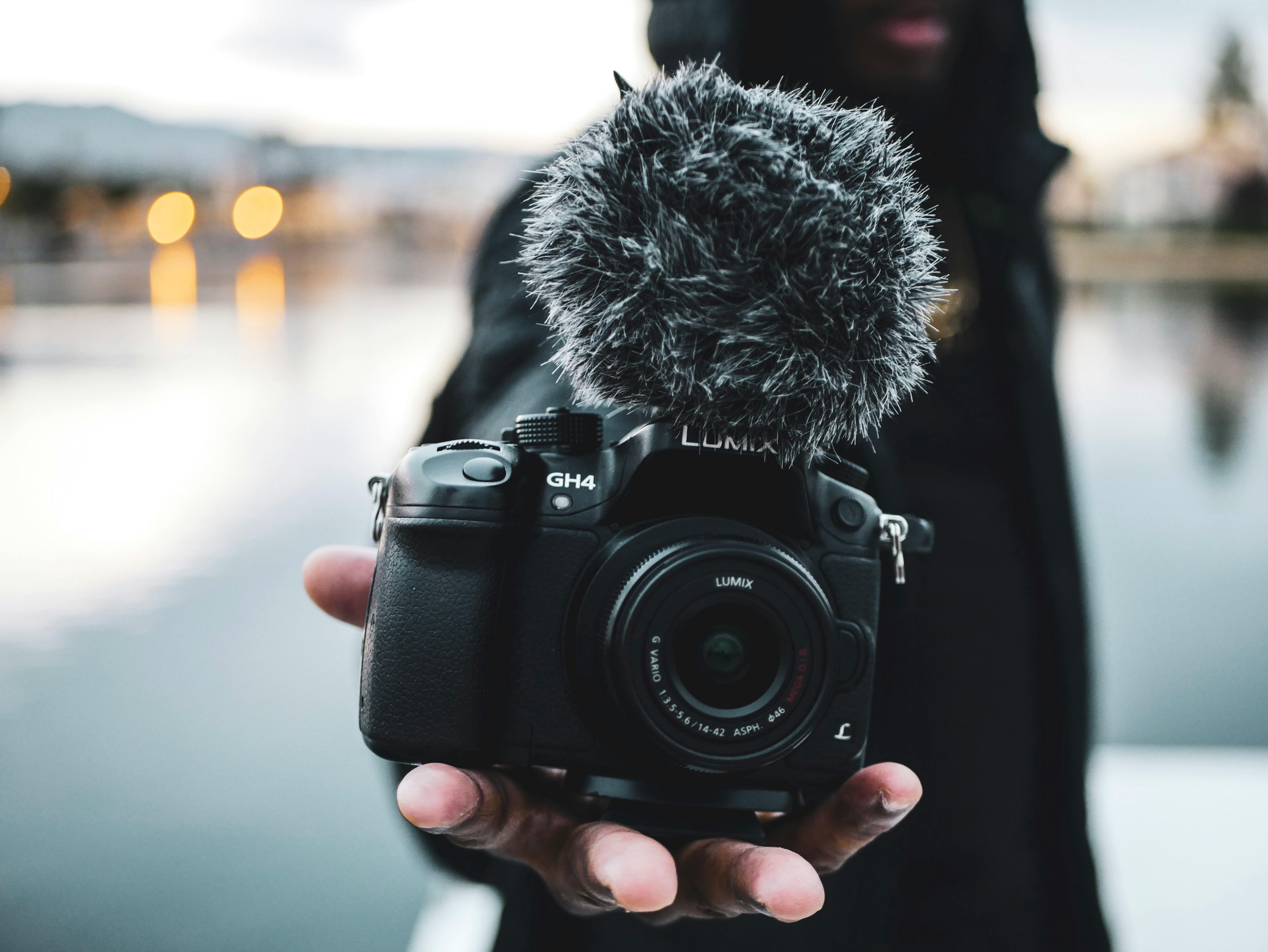 man holding black dslr camera