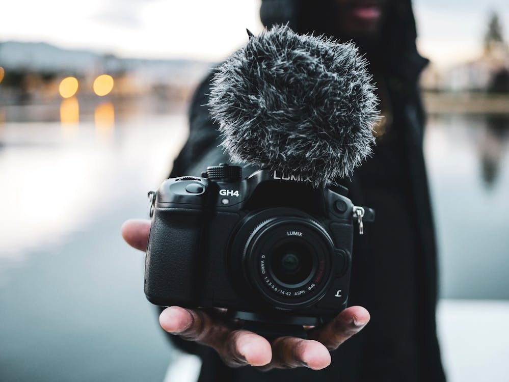 Man Holding Black Dslr Camera