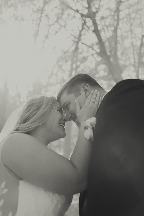 Black and White Photo of a Bride and Groom Embracing and Smiling 