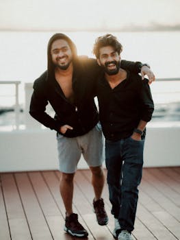 Two friends smiling at sunset on a yacht deck in Dubai. Perfect vacation vibes.