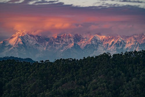 The mountains are covered in snow at sunset