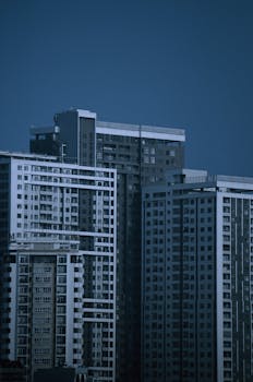 Contemporary apartment high-rises against a muted dusk sky. Perfect for cityscape enthusiasts.