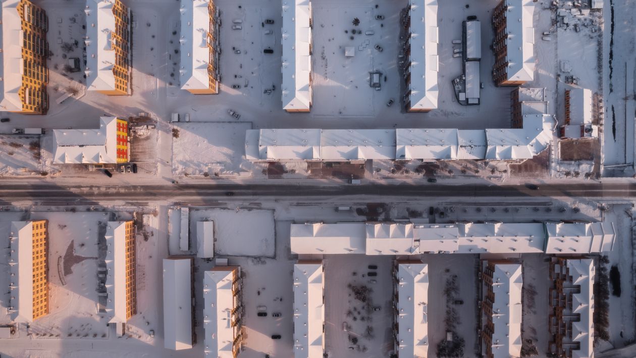 Drone Shot of Apartment Buildings Covered in Snow · Free Stock Photo