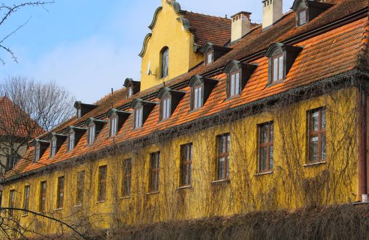 A yellow building with orange tiled roof