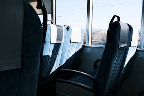 A view of the inside of a bus with blue seats