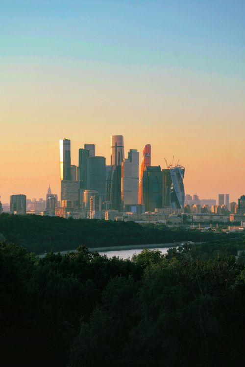 Free Stunning Moscow cityscape featuring contemporary skyscrapers at sunset, highlighting modern architecture. Stock Photo