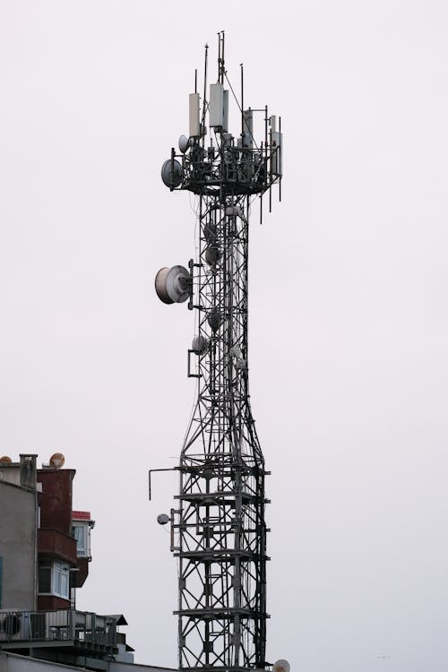 A cell phone tower with several antennas on top