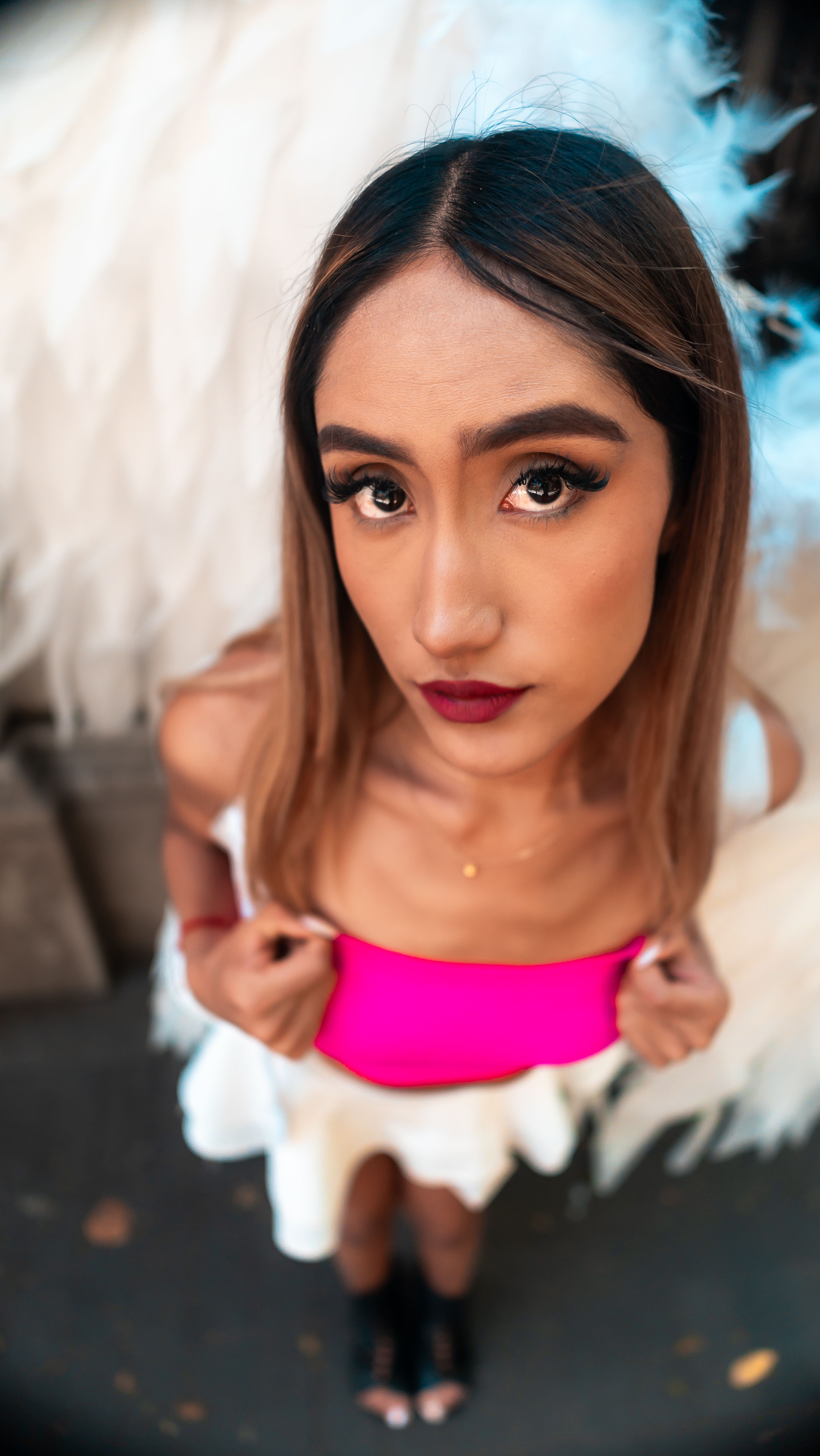 Artistic street portrait of a young woman with angel wings, expressing contemporary style in CDMX.