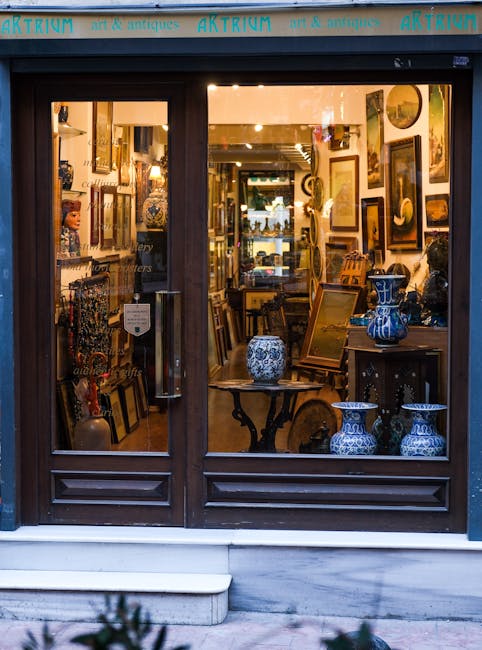 Charming antique shop window displaying vintage art and collectibles with elegant decor.