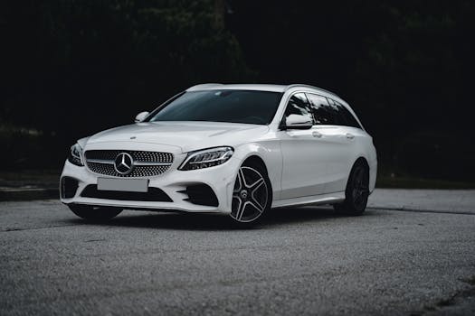 Elegant white Mercedes-Benz parked on an asphalt road, showcasing luxury design and style.