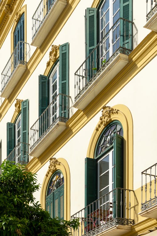 A building with green shutters and balconies