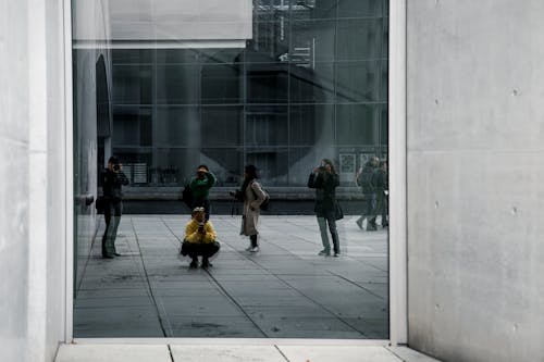 A person walking through a glass door with a child