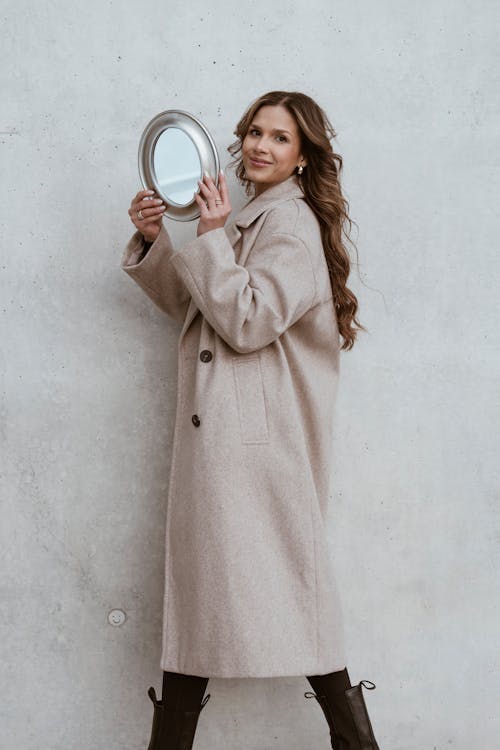 Woman in Coat and with Mirror
