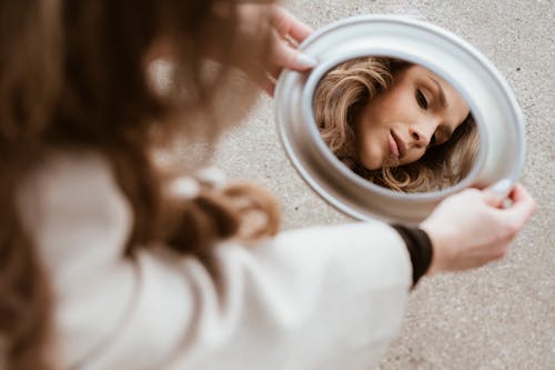 A woman looking at herself in a mirror
