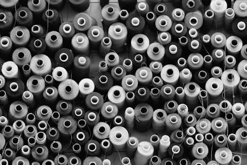 Black and White Photography of Thread Rolls