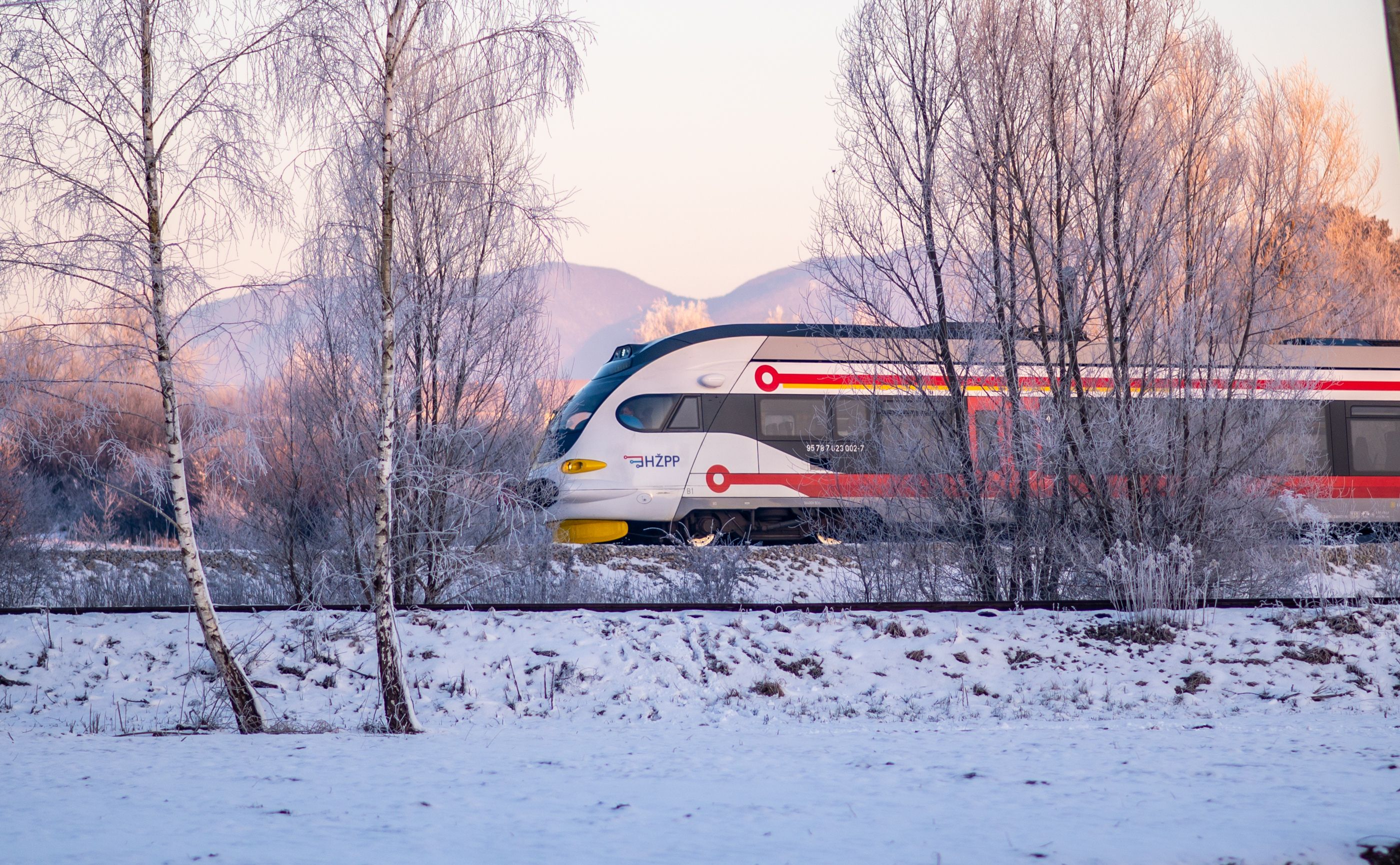 SJ high-speed train traveling through a picturesque Swedish landscape