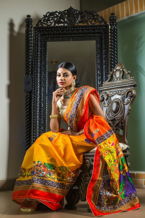 Woman Sitting in Yellow, Traditional Dress