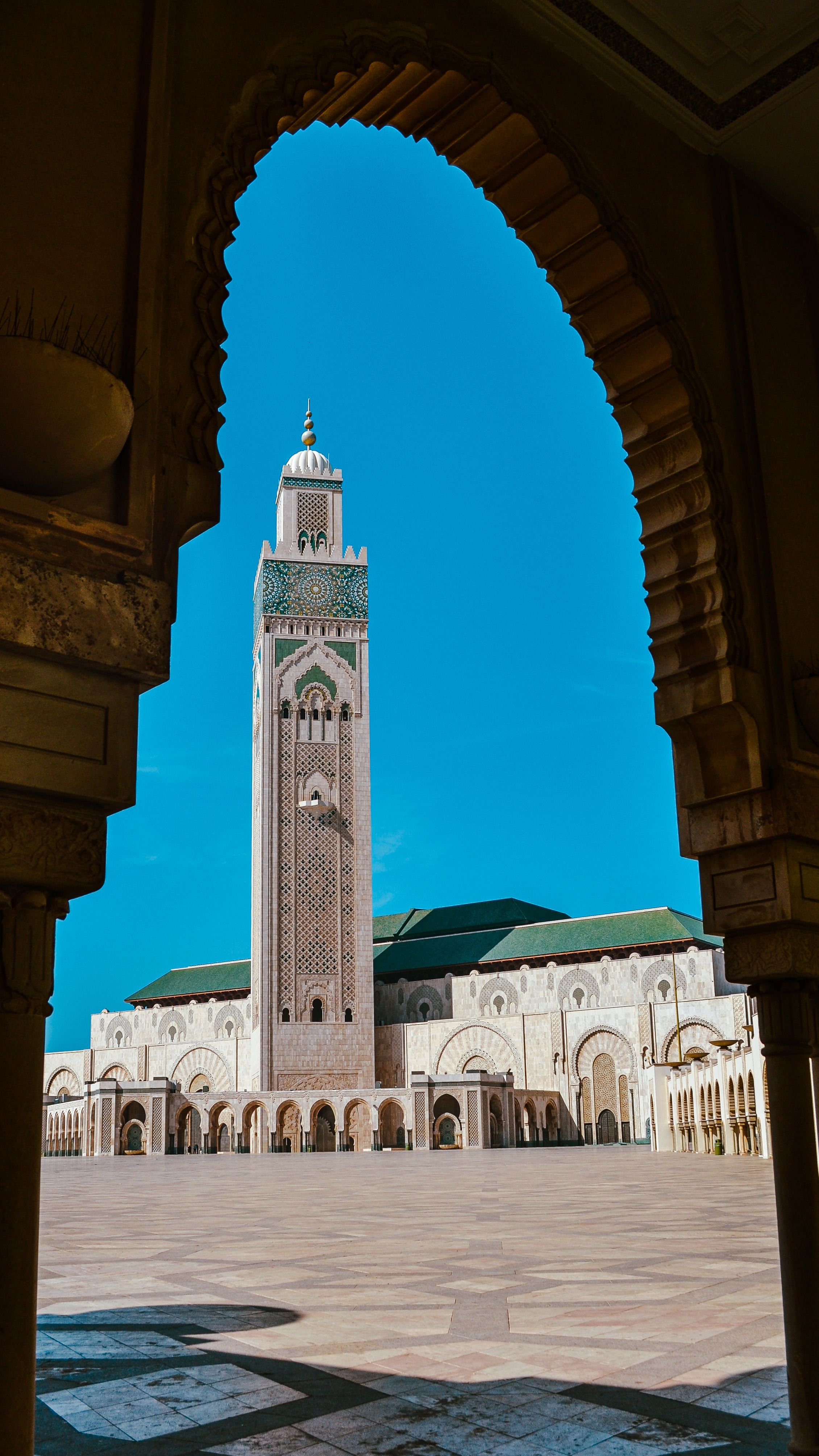 Hassan II Mosque in Casablanca framed by a traditional arch, showcasing Islamic architecture.