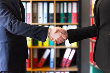 A handshake sealing the agreement between delegations