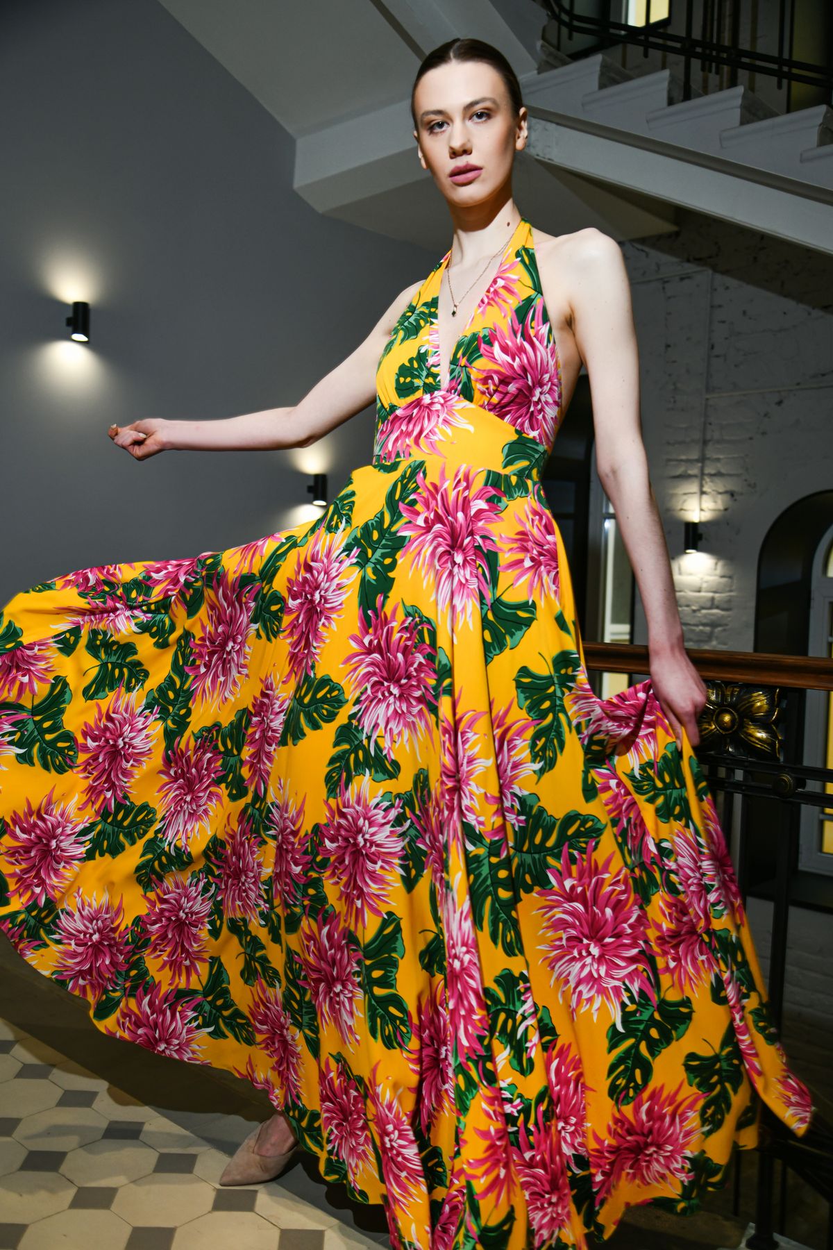 A woman in a yellow dress holding flowers, the bold summer floral