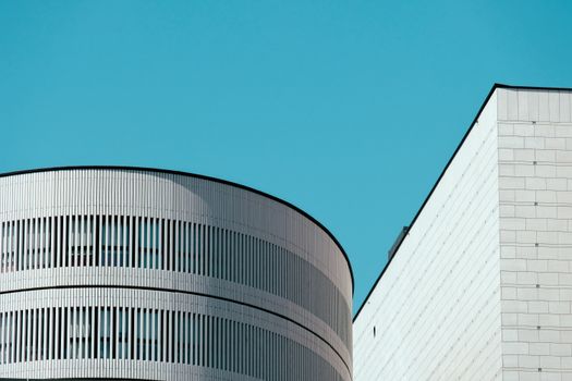 Minimalist architectural design with clean lines against a vibrant blue sky. Perfect for contemporary city visuals.