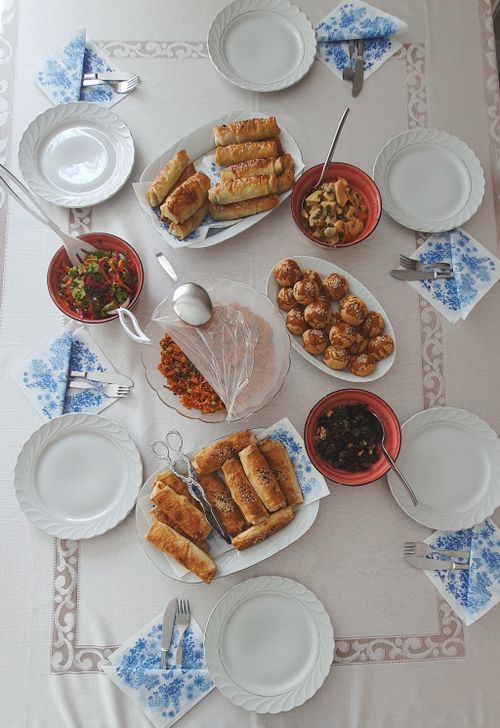 Free Traditional Turkish meal with pastries and salads on an elegant table setting viewed from above. Stock Photo