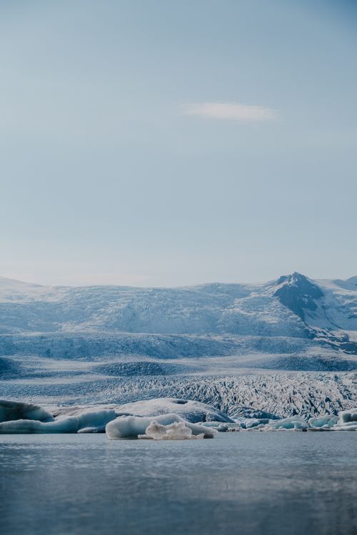 Free A breathtaking winter view of Jökulsárlón Lagoon with icy blue glaciers and mountains. Stock Photo