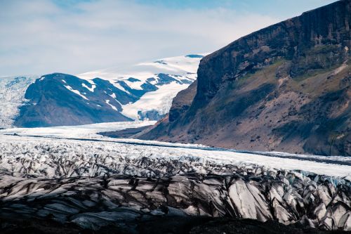 Free Breathtaking view of Iceland's glacier with rugged mountains and a clear sky. Stock Photo
