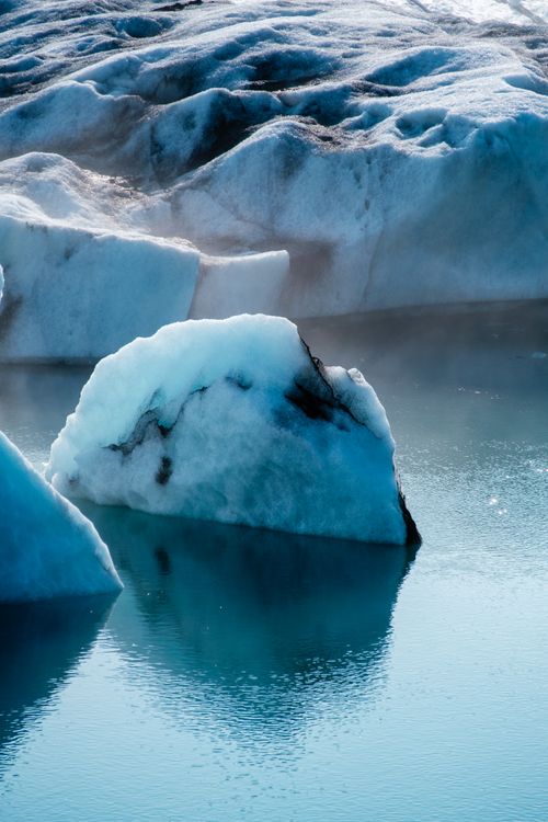 Free Stunning icebergs at Skaftafellsjökull glacier reflecting in clear blue water. Stock Photo