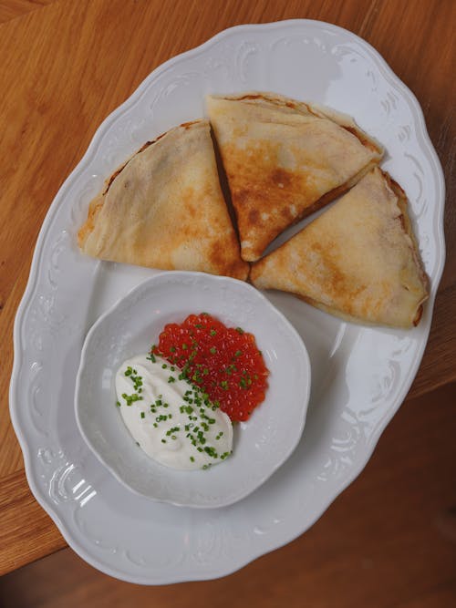 A white plate topped with two pieces of food