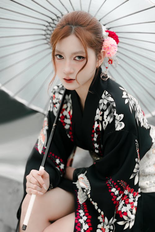 A woman in a kimono holding an umbrella
