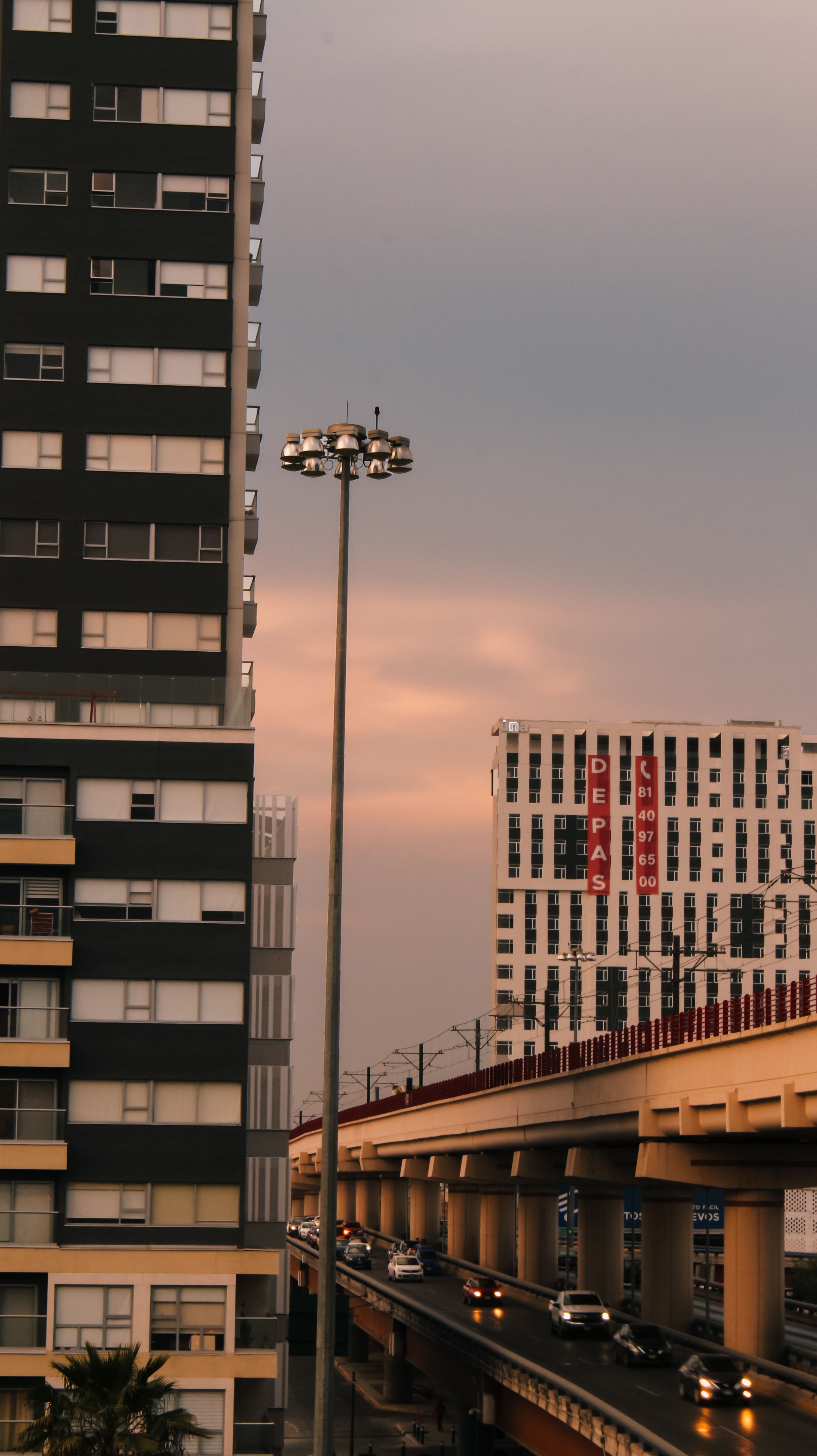 A city street with tall buildings and a street light · Free Stock Photo