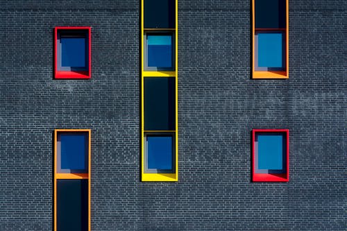 Free A black and white photo of a building with many windows Stock Photo