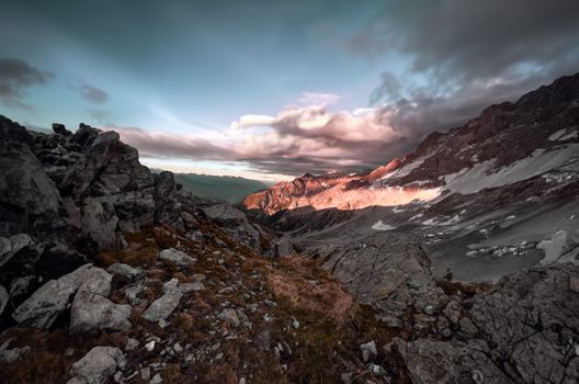 Breathtaking view of rugged mountain landscape in Brescia, Lombardy with dramatic sunset lighting.