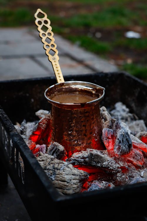 A cup of tea is being served on a fire