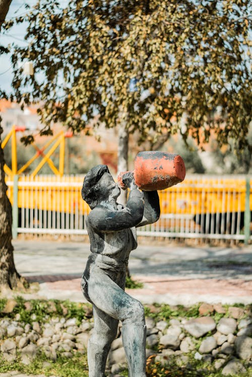 A statue of a man holding a water jug
