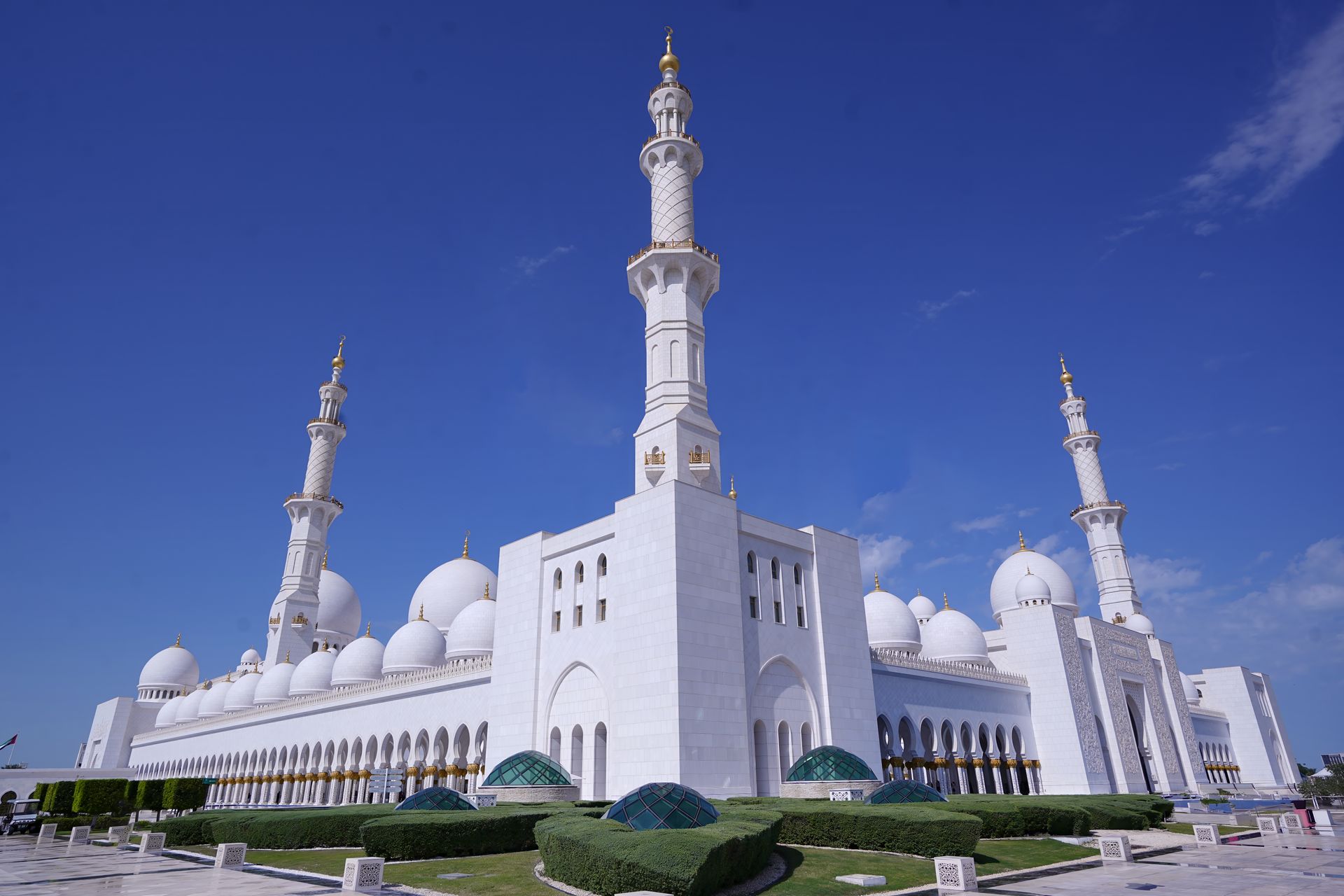 Stunning view of the Sheikh Zayed Grand Mosque showcasing its iconic white domes and minarets agains
