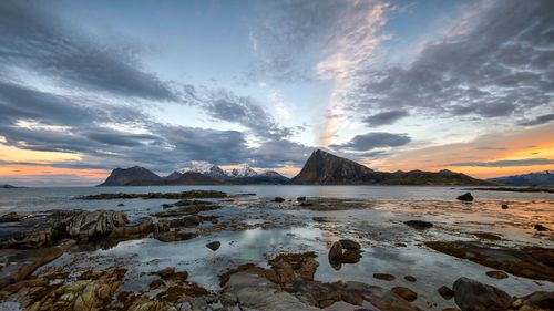Free Breathtaking view of Napp's mountain range during sunset, with ocean reflections. Stock Photo