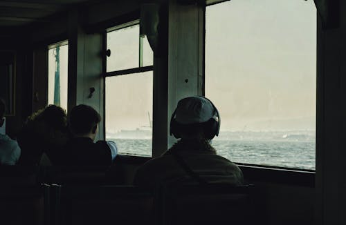 A group of people sitting on a boat looking out at the water