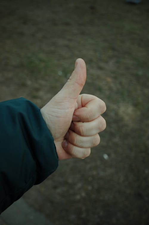 A person giving a thumbs up with their hand