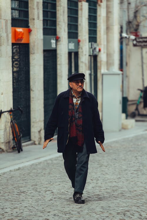 Man Walking Cobblestone Street