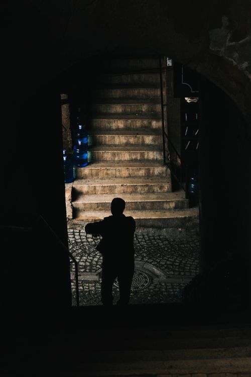 Free A silhouetted figure walks in a dimly lit alley with cobblestone steps in Istanbul. Stock Photo