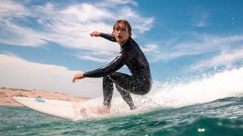 Surfer Surfing on Sea Shore