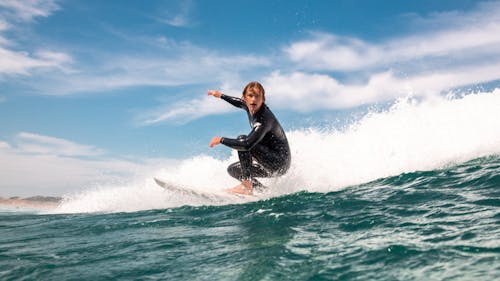 Man Surfing on Sea Shore