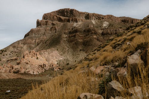 A mountain with rocks and grass in the background