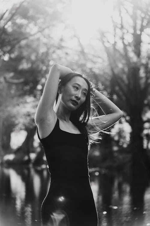 Woman Standing with Arms Raised in Black and White