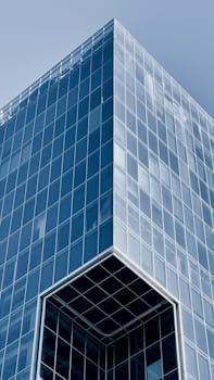 Modern glass skyscraper in Santiago, Chile, showcasing sleek architectural design with reflective surfaces.