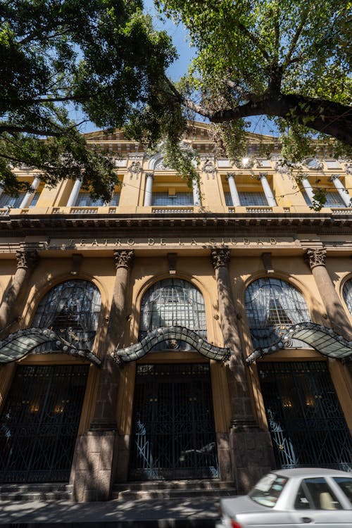 A building with a large window and a car parked in front