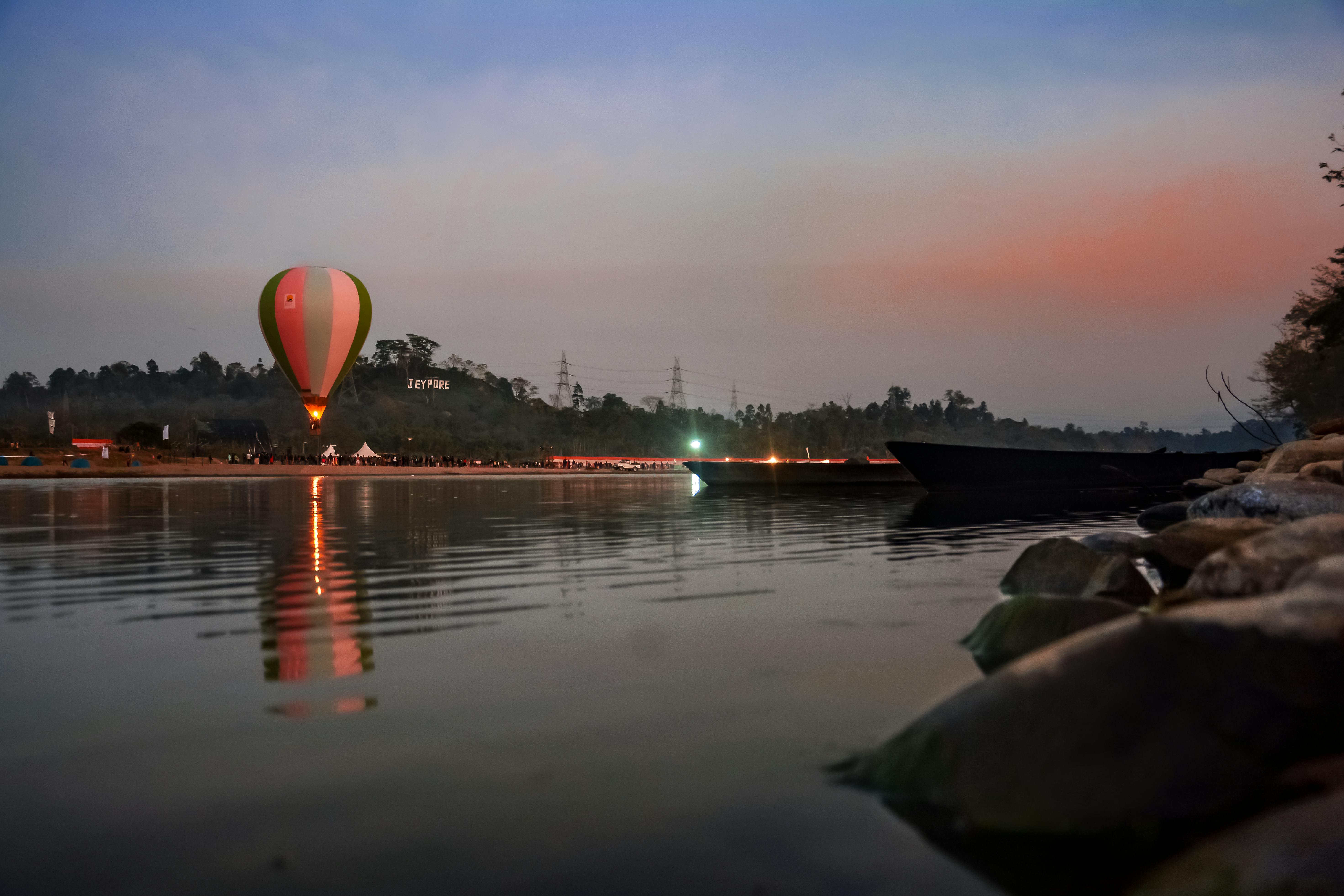 Hot Air Balloons Floating over the Water during Sunset · Free Stock Photo