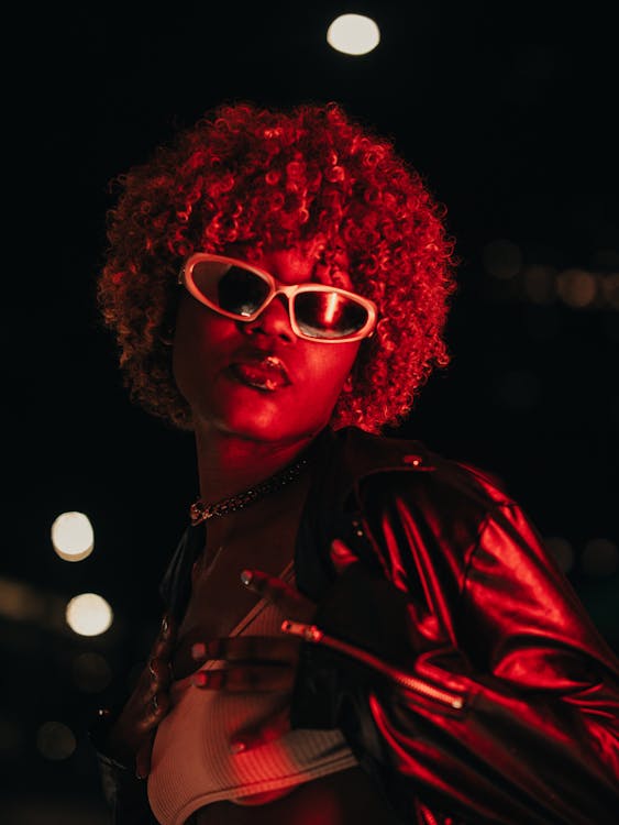 Fashion model with curly hair in red lighting 